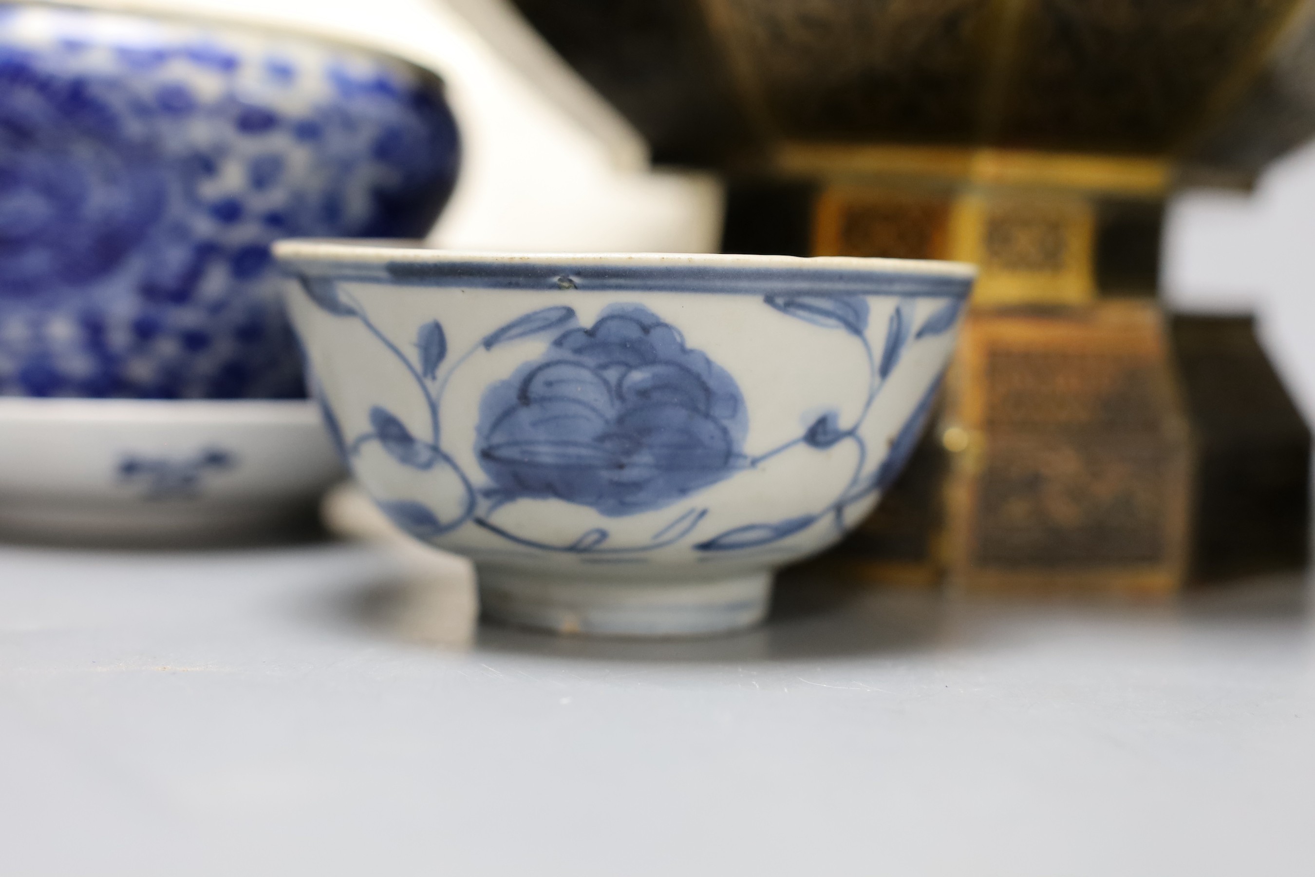 A collection of Chinese blue and white tea bowls, a vase, metal planter and book on Hong Kong by John and Veronica Stericker, (7)